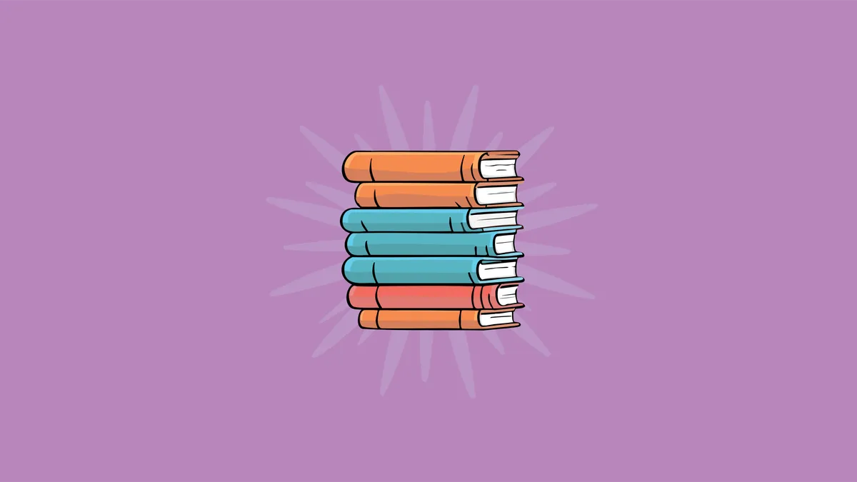 A pile of different sized books stacked on top of each other. The books have orange, blue and hot red covers. They are on a p